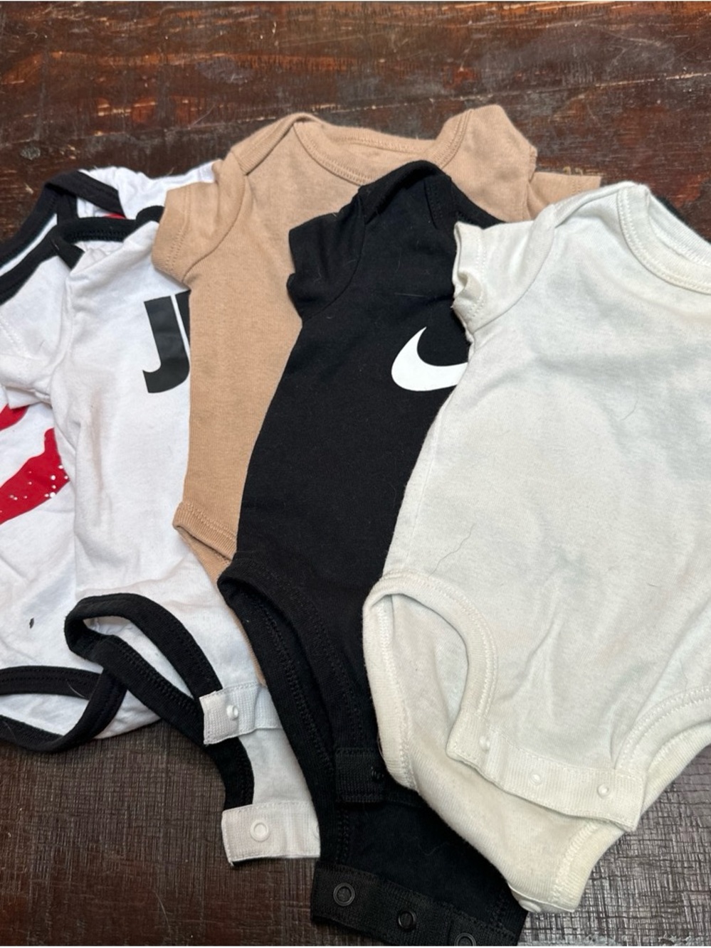 Nike Baby Bodysuit Lot with Black Logo and Neutral Tones